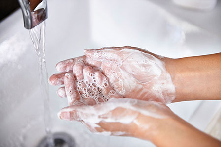 Hands with lathered soap in sink, about to be rinsed with water. If you are struggling with OCD in Florida, get started with CBT and ERP therapy.